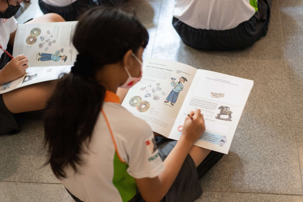 Student holding an activity booklet