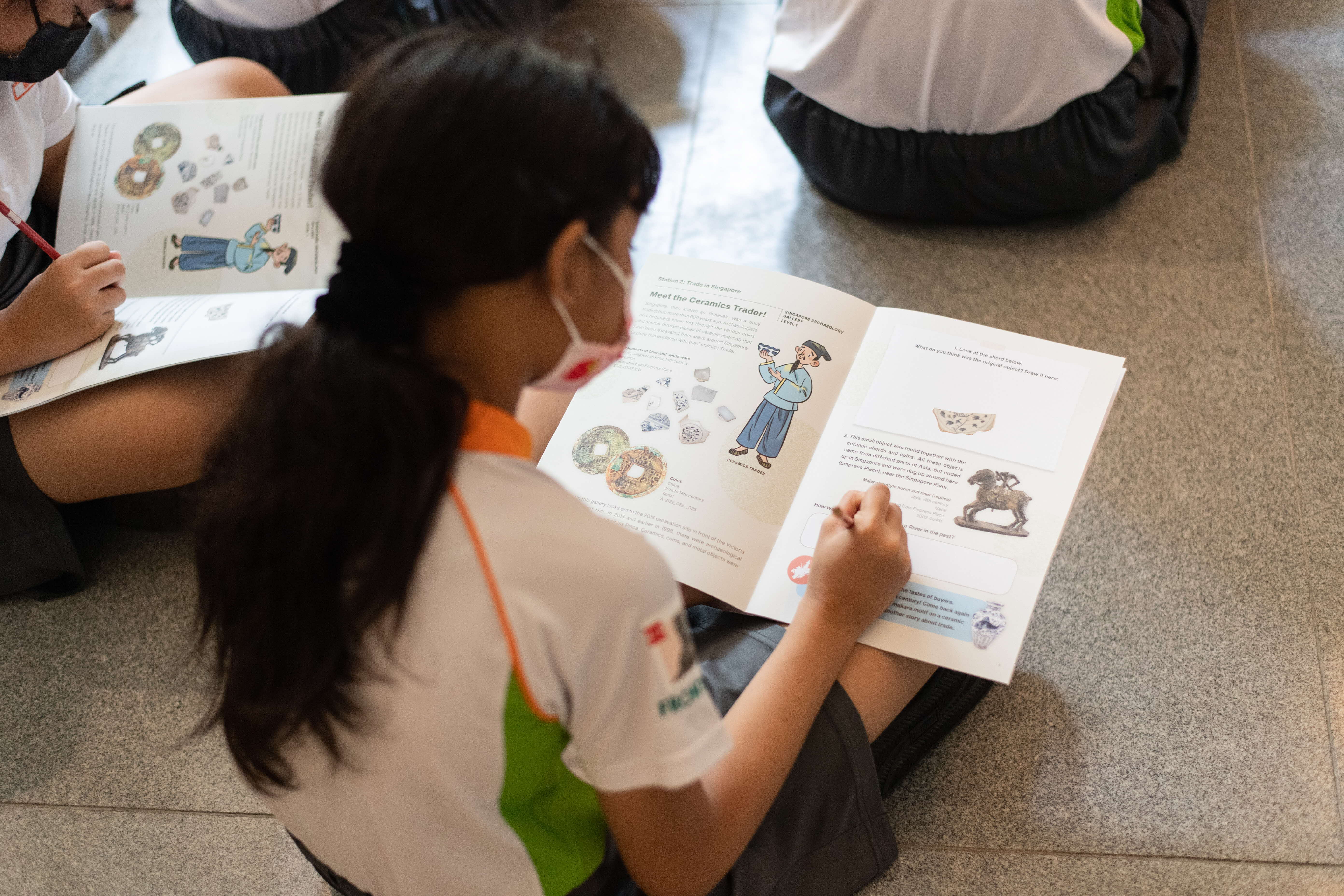 Primary school students completing a worksheet in the ACM galleries