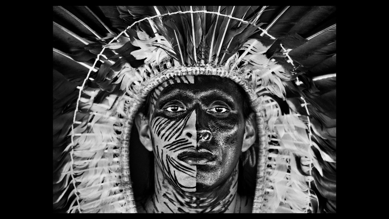 Adão Yawanawá in a headdress of eagle feathers